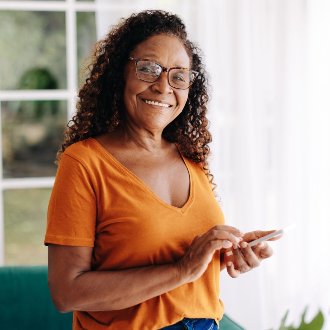 An older adult smiling while talking on the phone